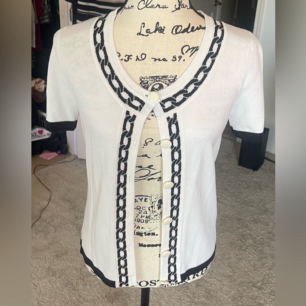A lovely white with black trim cardigan sweater, short sleeve size medium